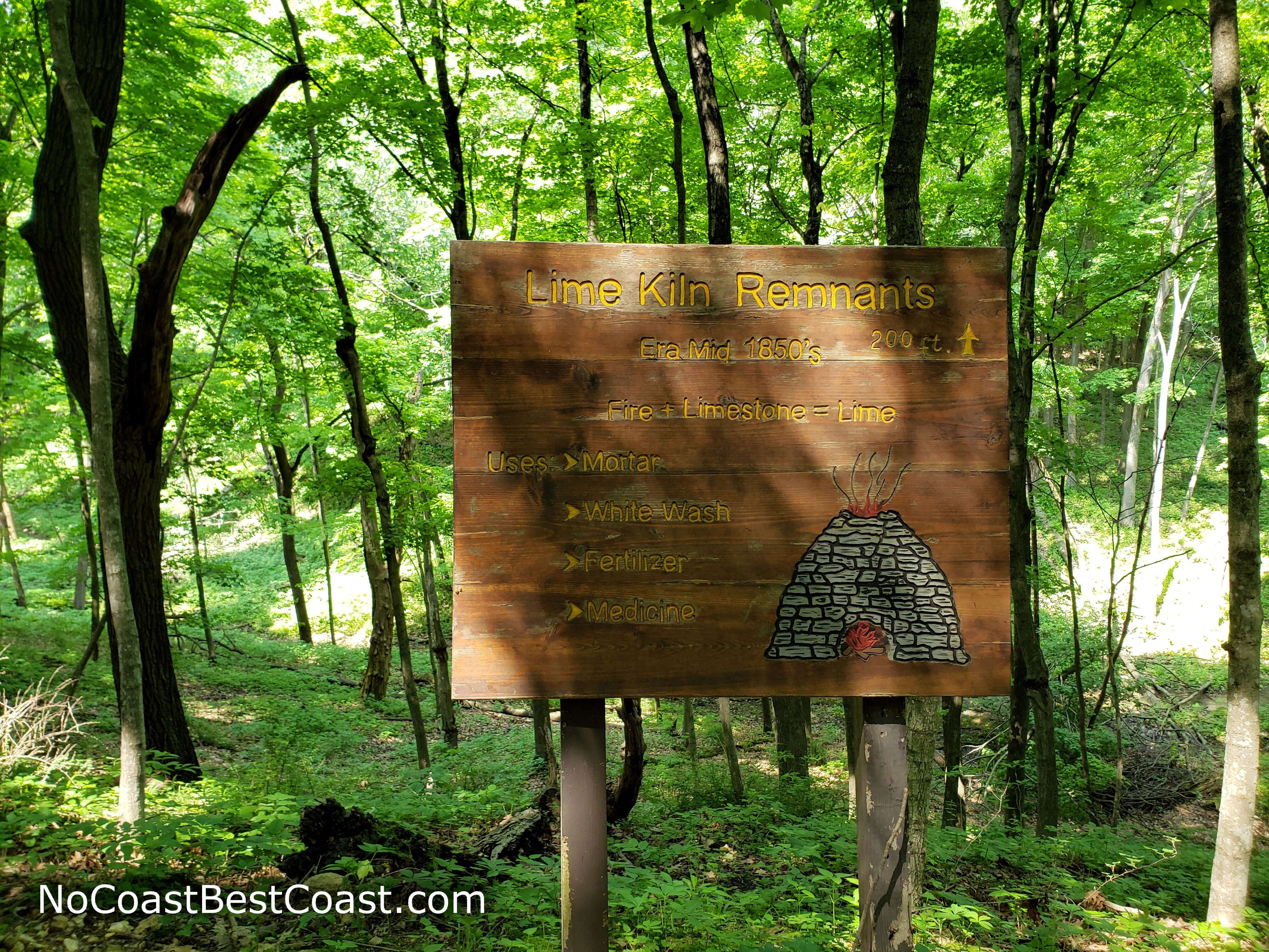 This sign marks the lime kiln ruins which can be seen further down the ravine.
