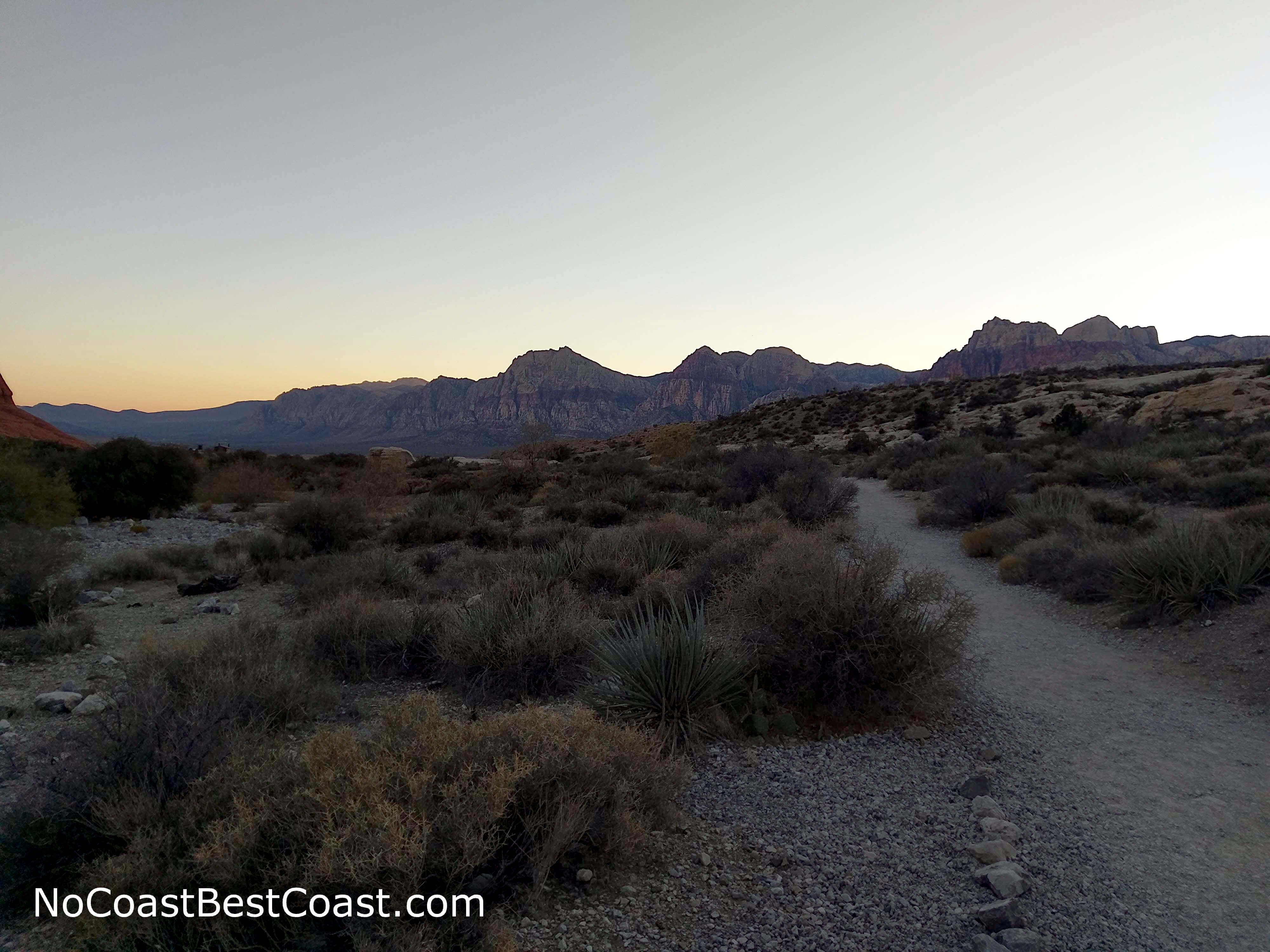 The sun setting with the walls of Red Rock Canyon in the distance
