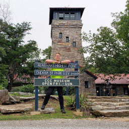 The sign, observation tower, and CCC Museum at the summit of Cheaha Mountain