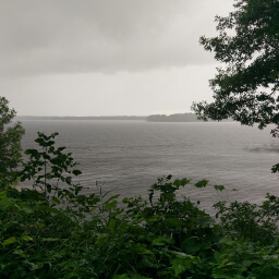 Peeking through the forest at the stormy waters of Mille Lacs Lake