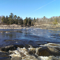Water rushes over the many river rocks