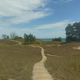 The cordwalk extending across the dunes with Lake Michigan in the background