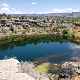 The blue of Montezuma Well contrasting with the brown desert