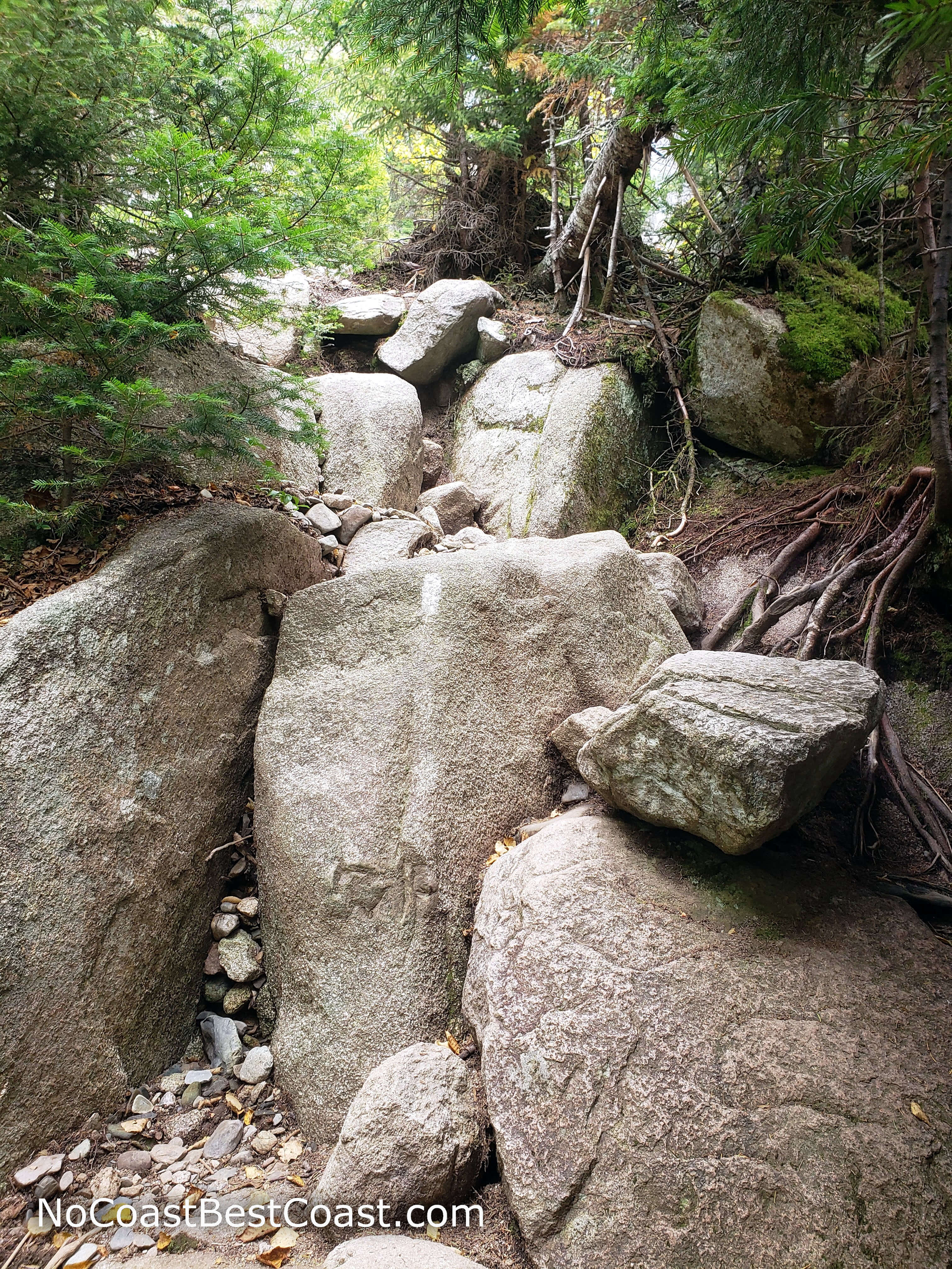 You'll have to climb up many boulders like these on this steep trail