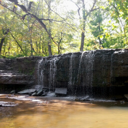 The small Hidden Falls trickles over the rocky ledge