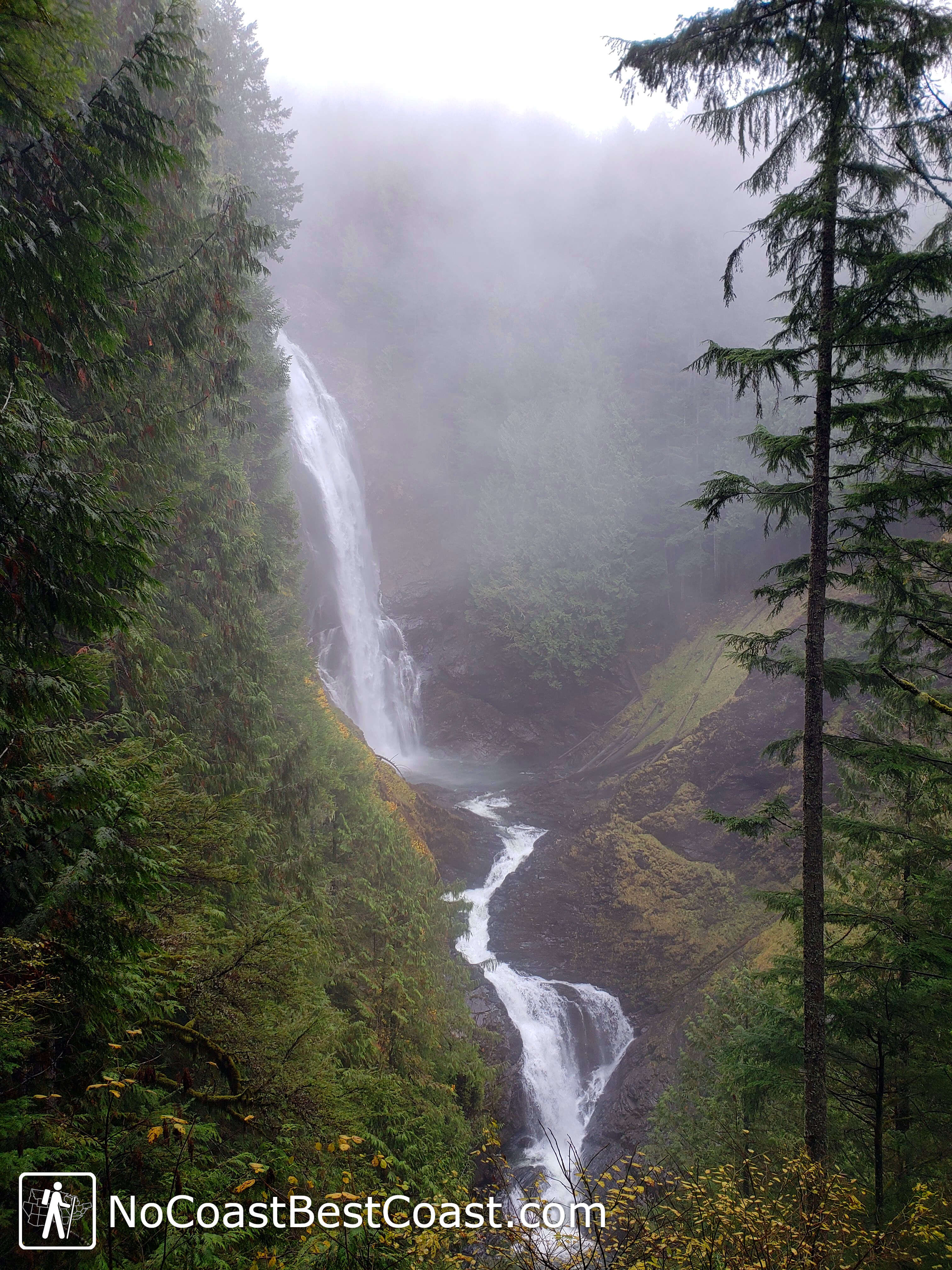 Middle Wallace Falls shrouded in mist and surrounded by moss