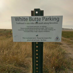 This white sign designates the parking area for White Butte