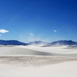 The San Andres Mountains beyond the blowing white sand