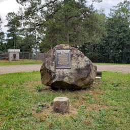 The boulder and plaque at the summit of Woodall Mountain